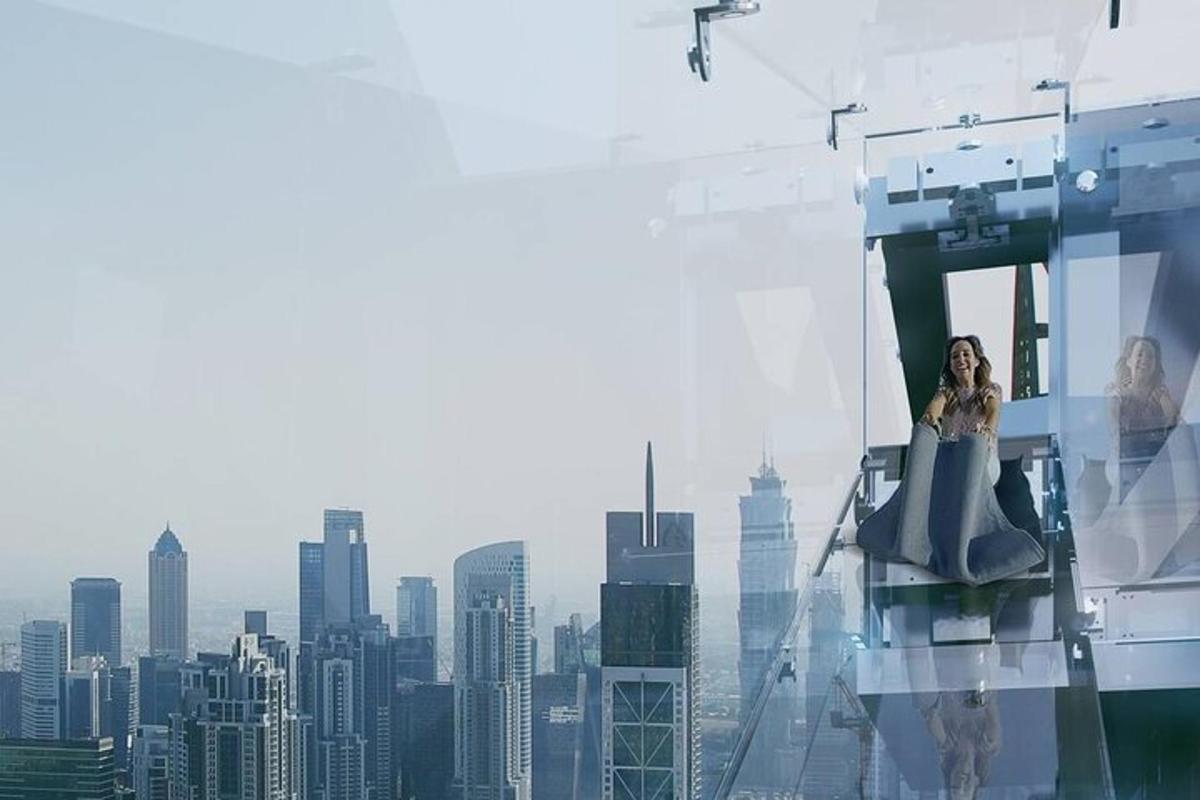 a woman sitting on top of a building with a city