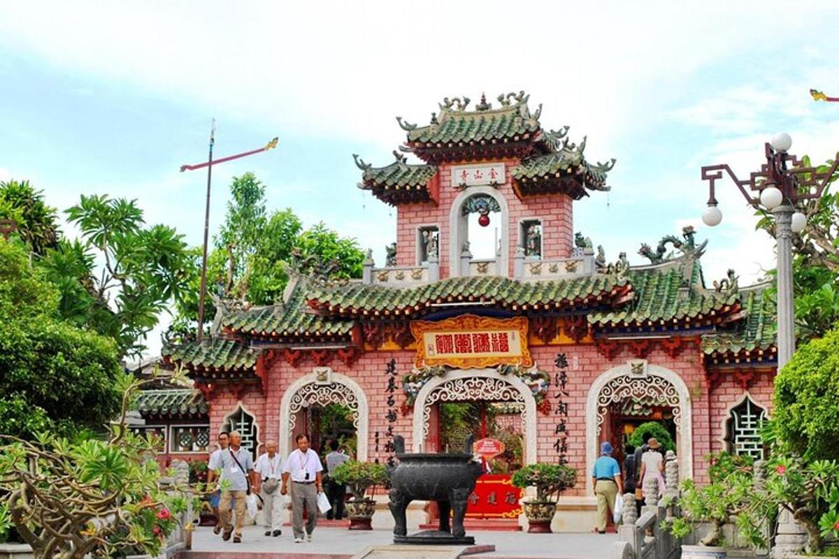 a building in a park with people walking around it