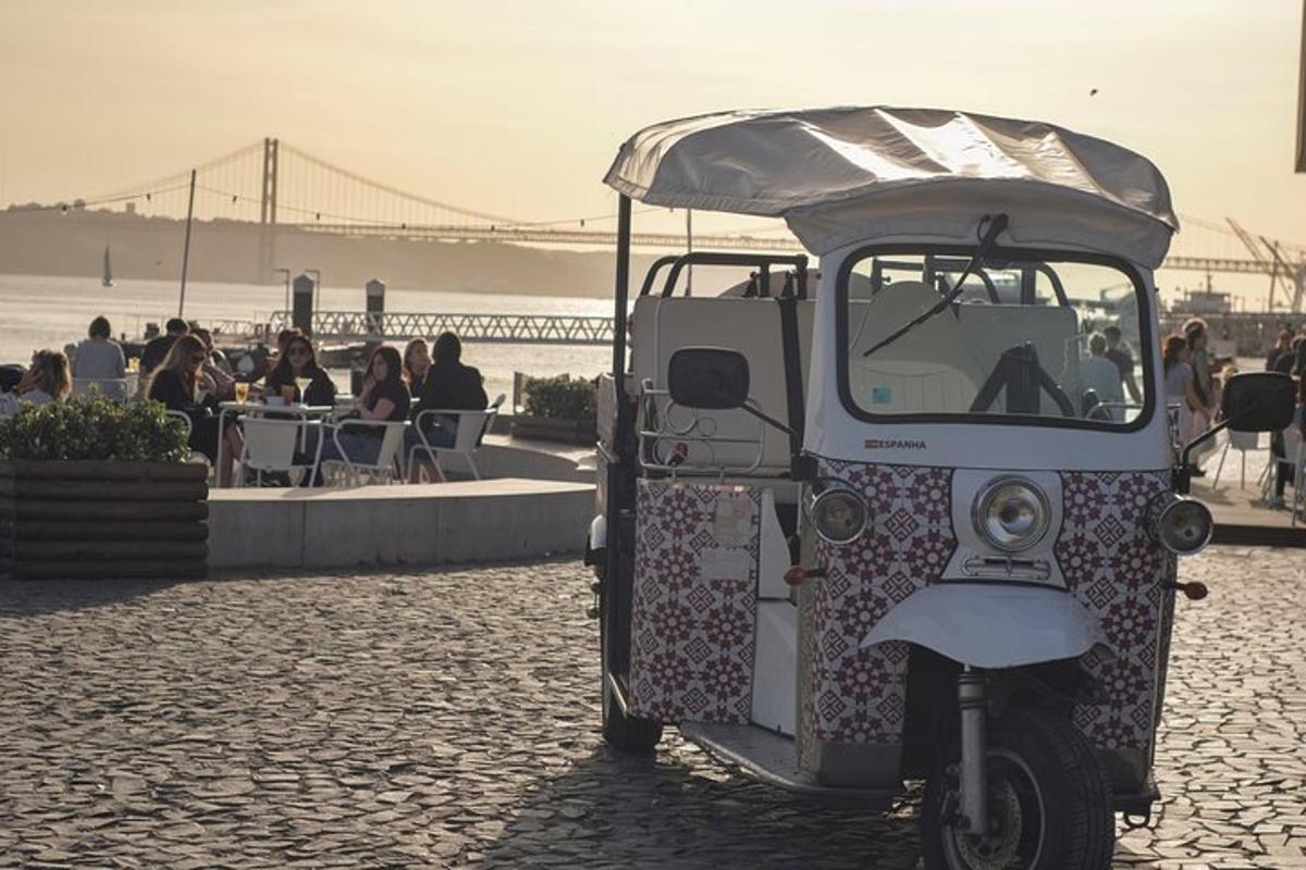 a small vehicle parked on the beach with people eating