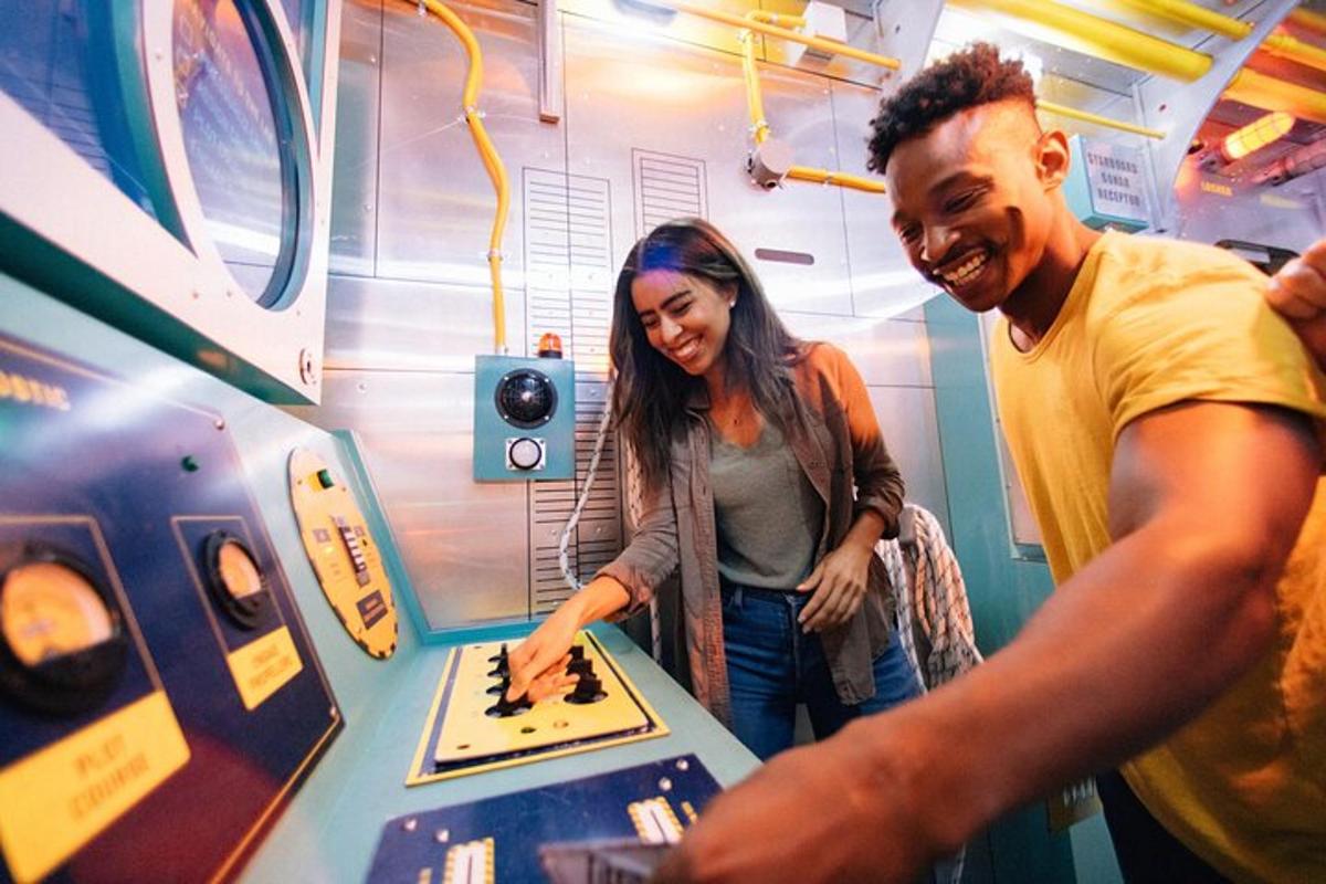 a man and a woman cutting a cake at a machine