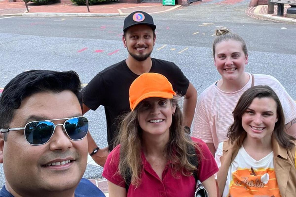 a group of people posing for a picture on the street