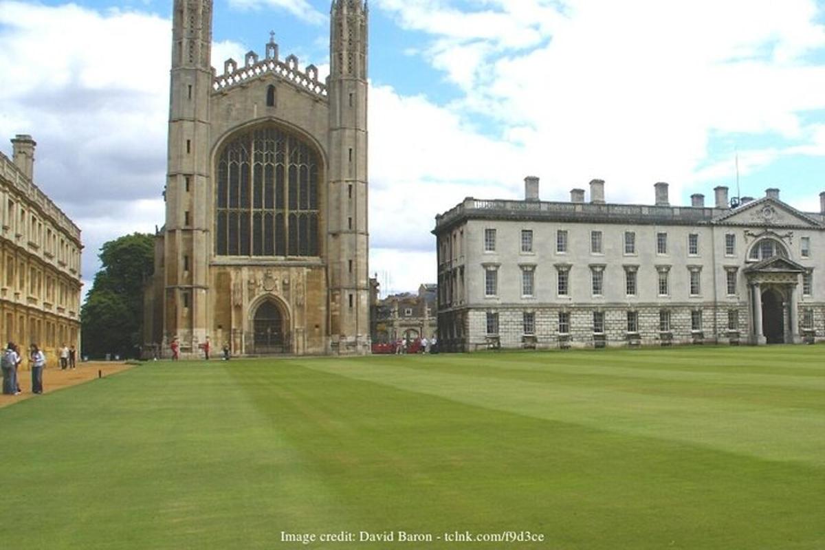 a large building with a large grass field in front of it