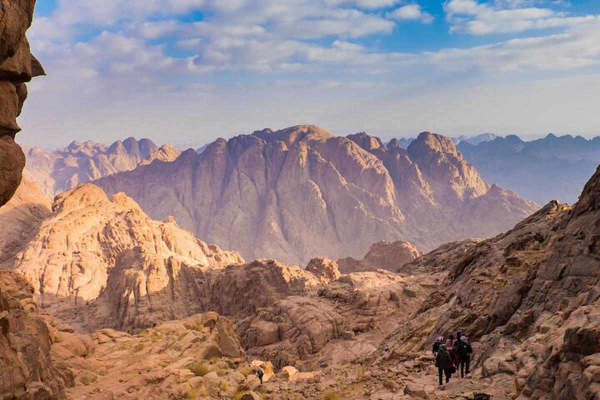 un grupo de personas caminando por una cadena montañosa