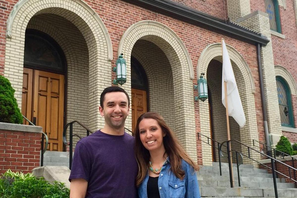 a man and a woman standing in front of a building