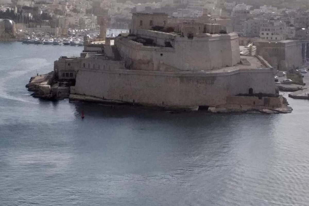 an old building in the middle of a body of water