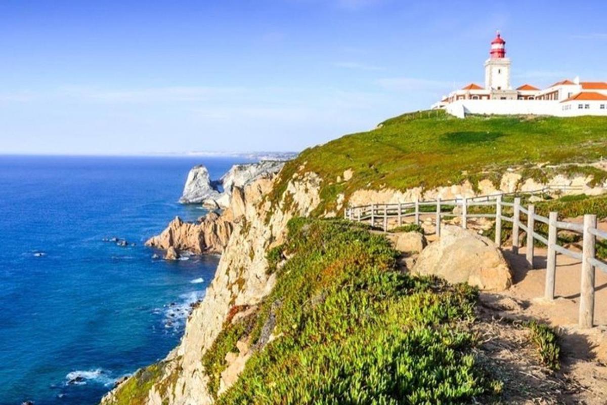 a lighthouse on a cliff next to the ocean