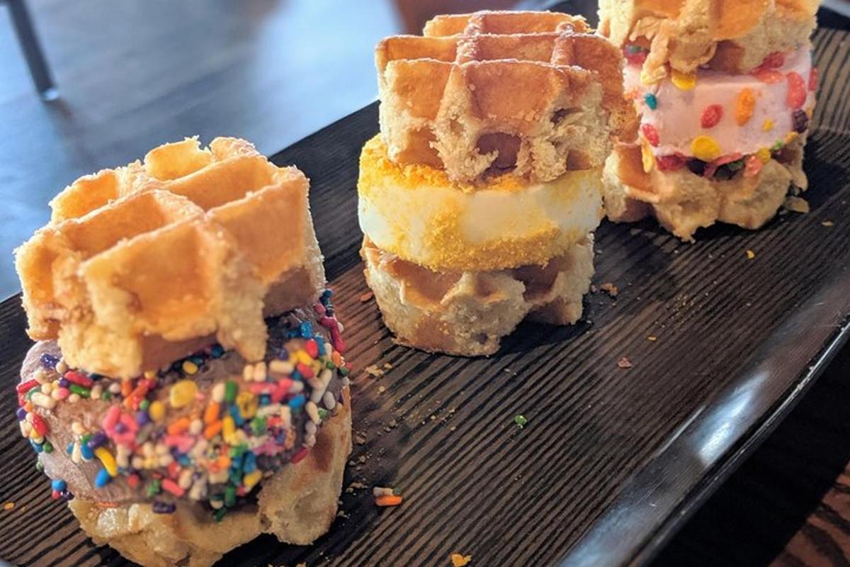 a plate with three waffles and sprinkles on it