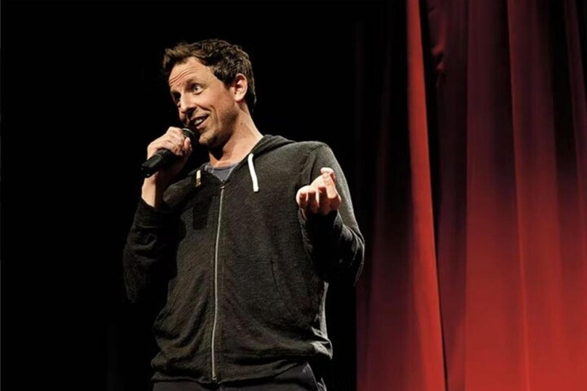 a man singing into a microphone on a stage