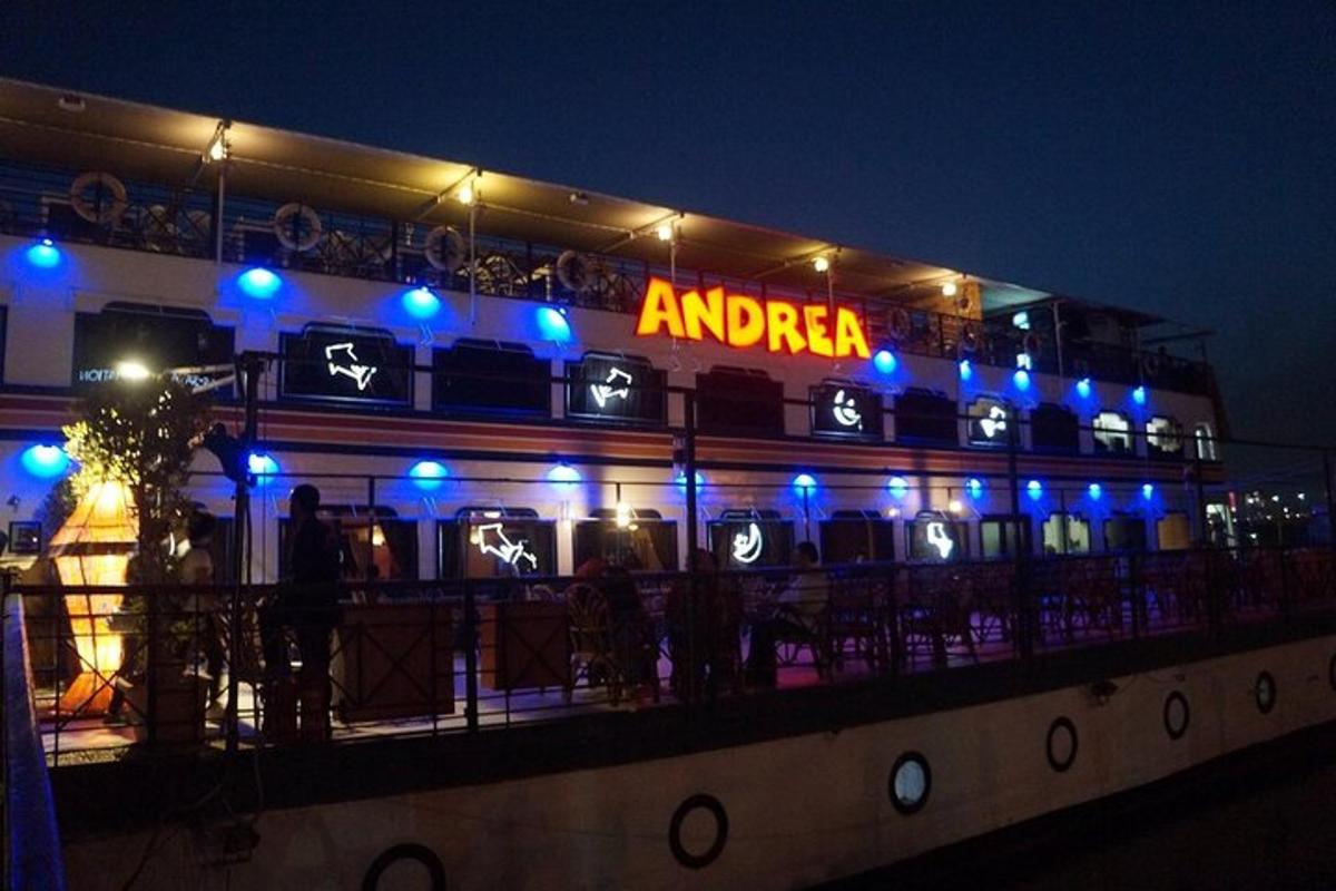 a bar with a sign on top of it at night