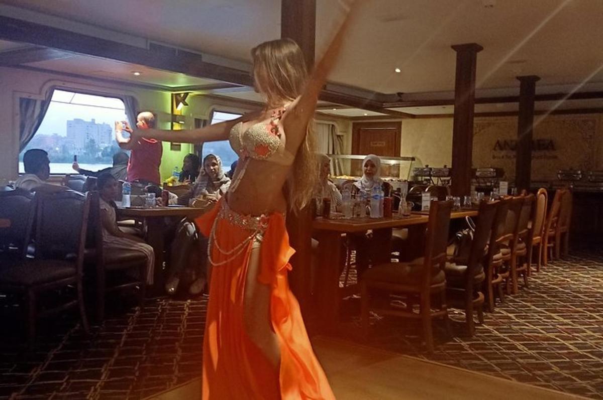 a woman in an orange dress dancing in a restaurant