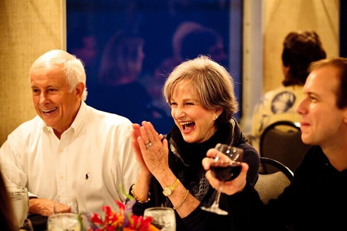 a man and a woman sitting at a table laughing