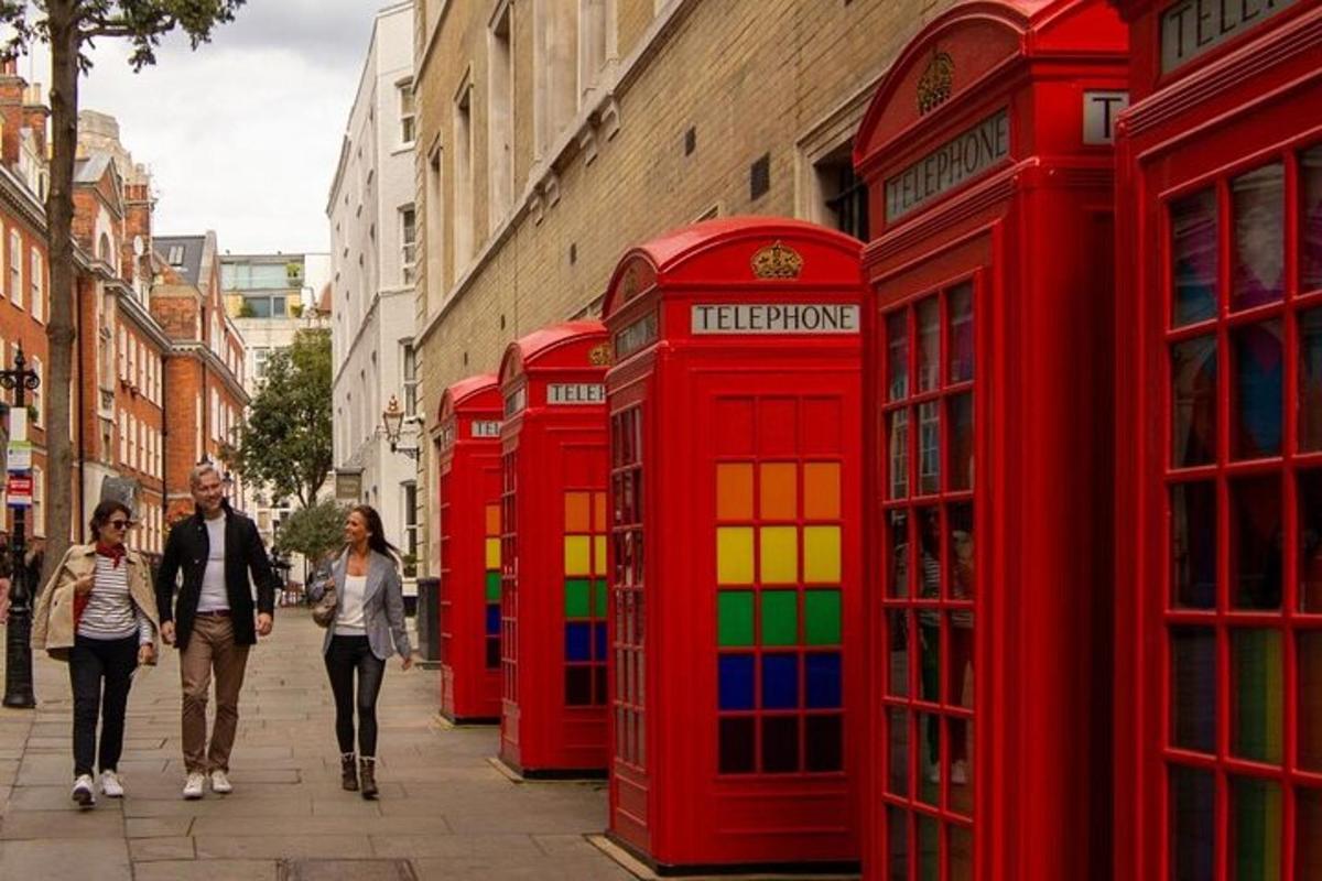 a group of red phone booths on a street