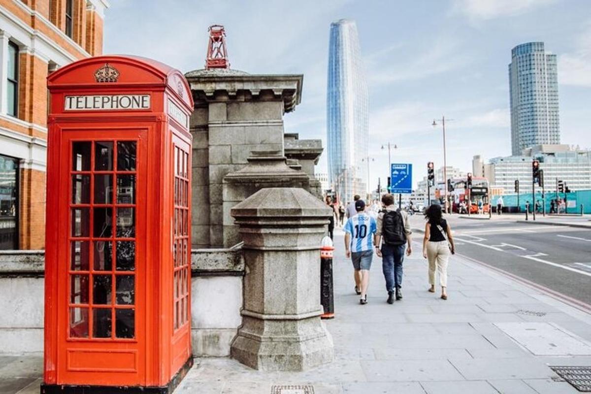a red phone booth and people walking down a street