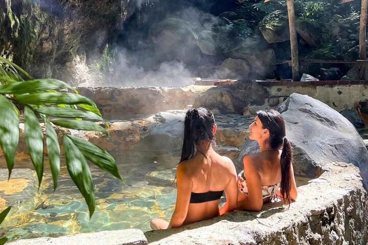 two women sitting in a pool of water