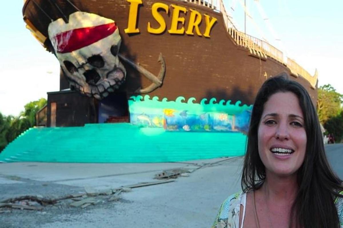 a woman standing in front of a pirate ship