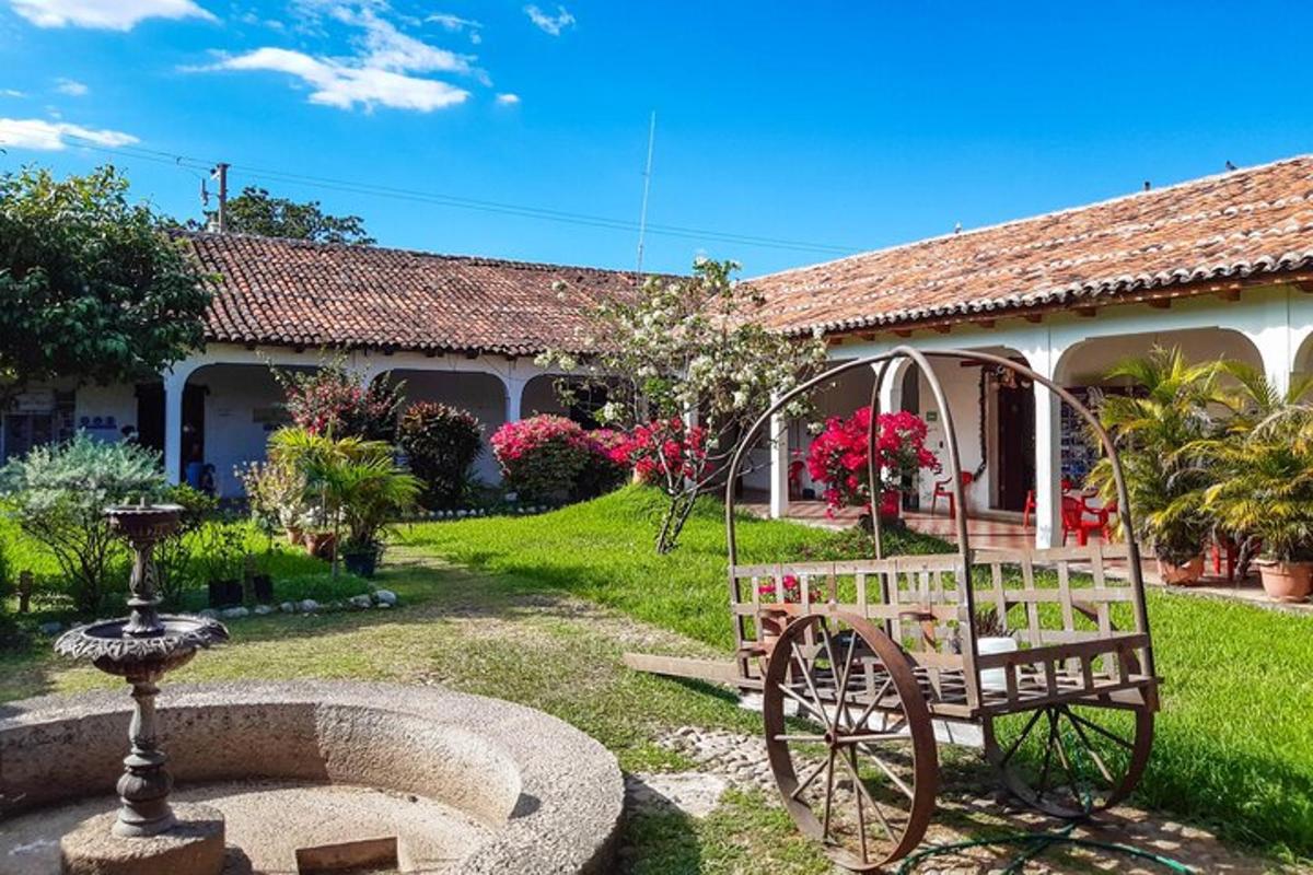 a garden with a bench in front of a house