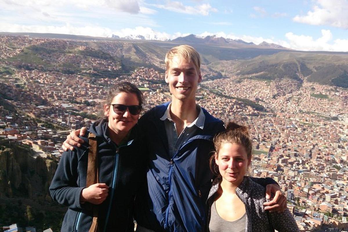 a man and a woman standing on top of a mountain