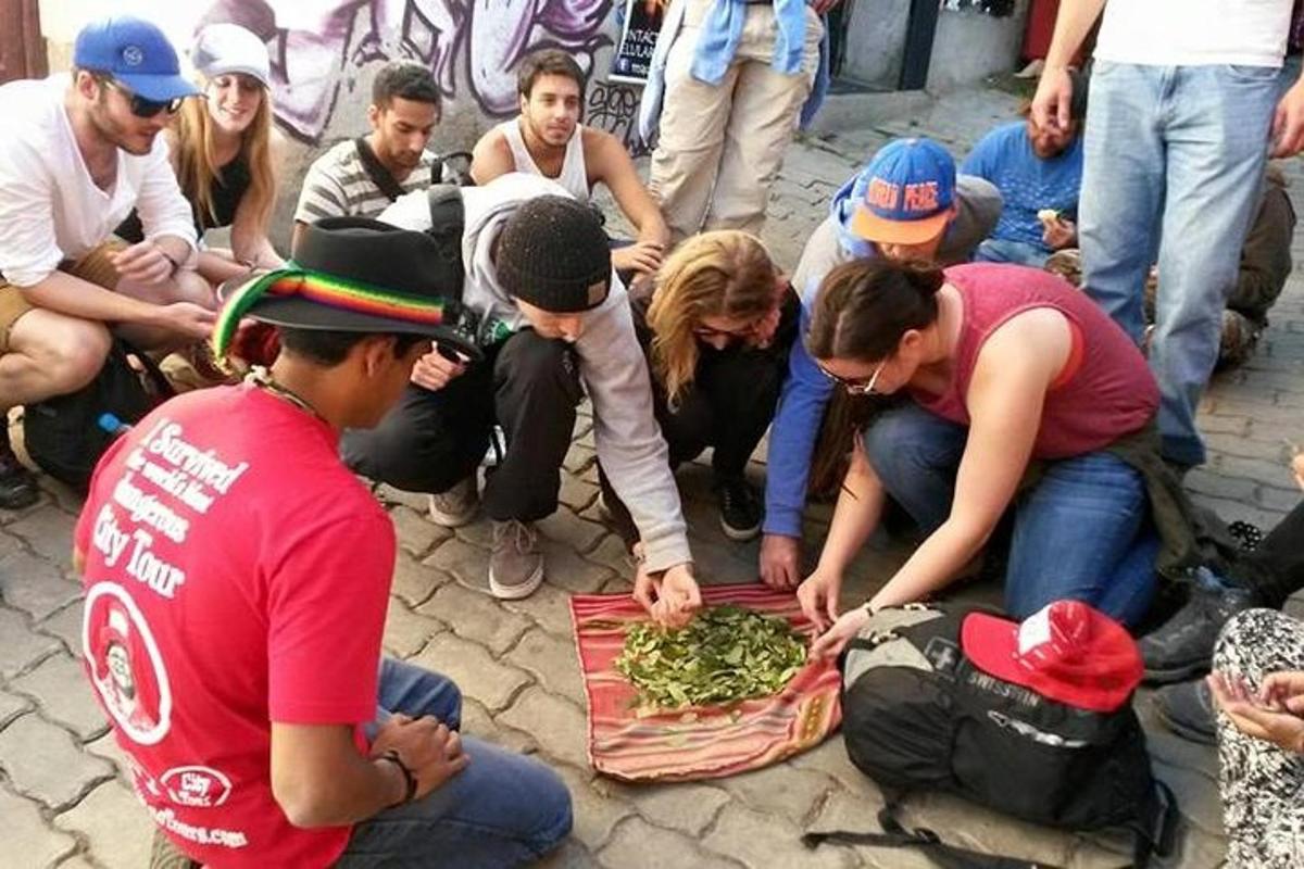a group of people looking at a tray of food