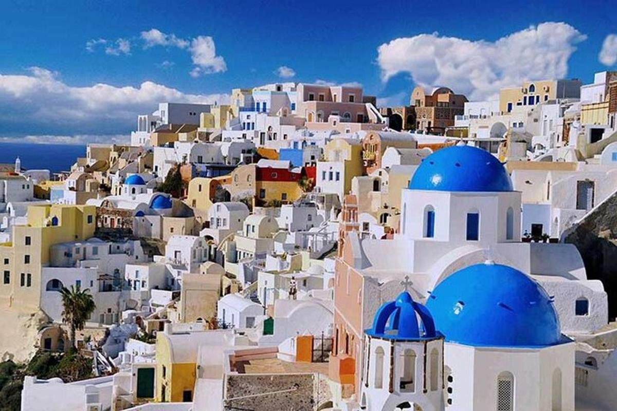 a view of a village with white buildings and blue domes