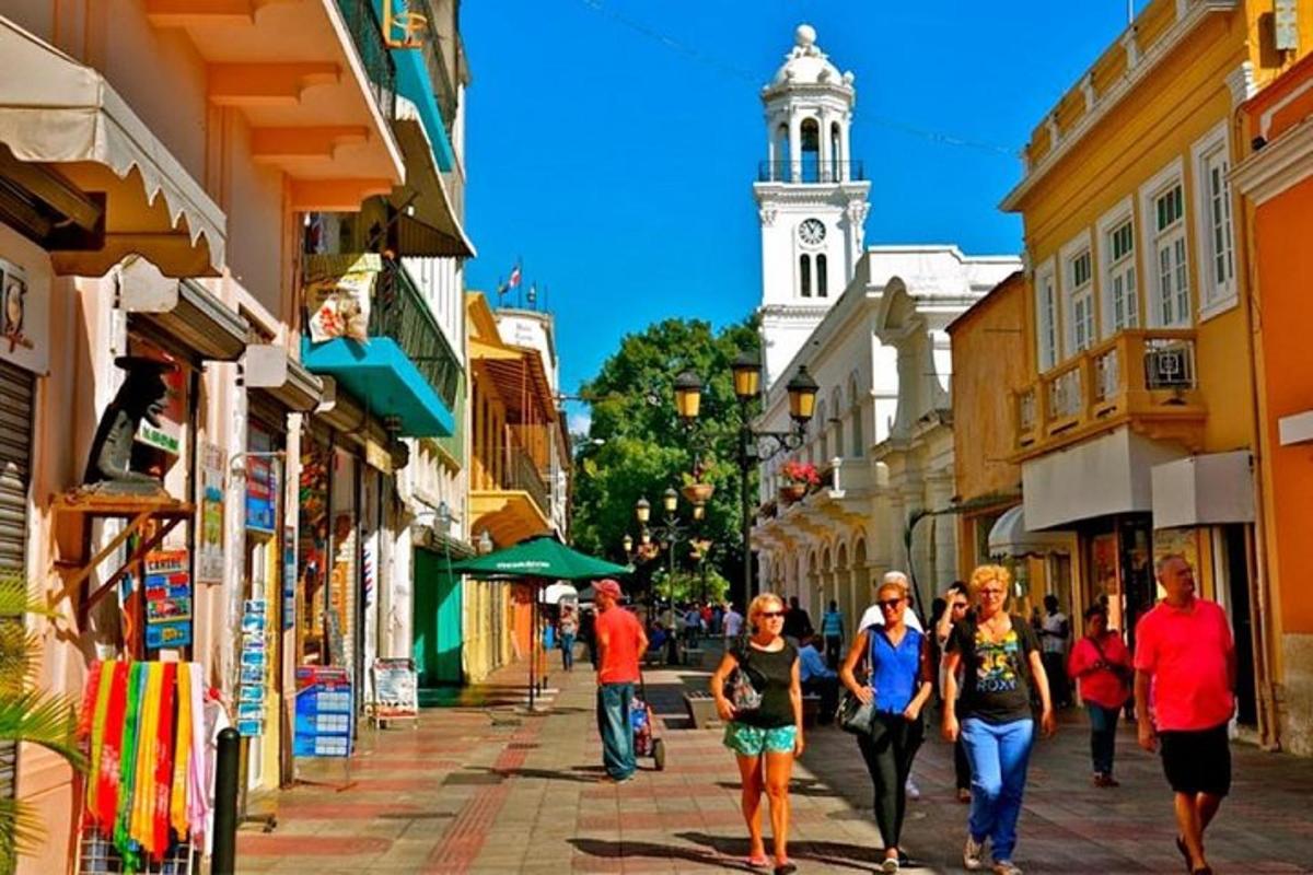 a group of people walking down a street with a clock tower