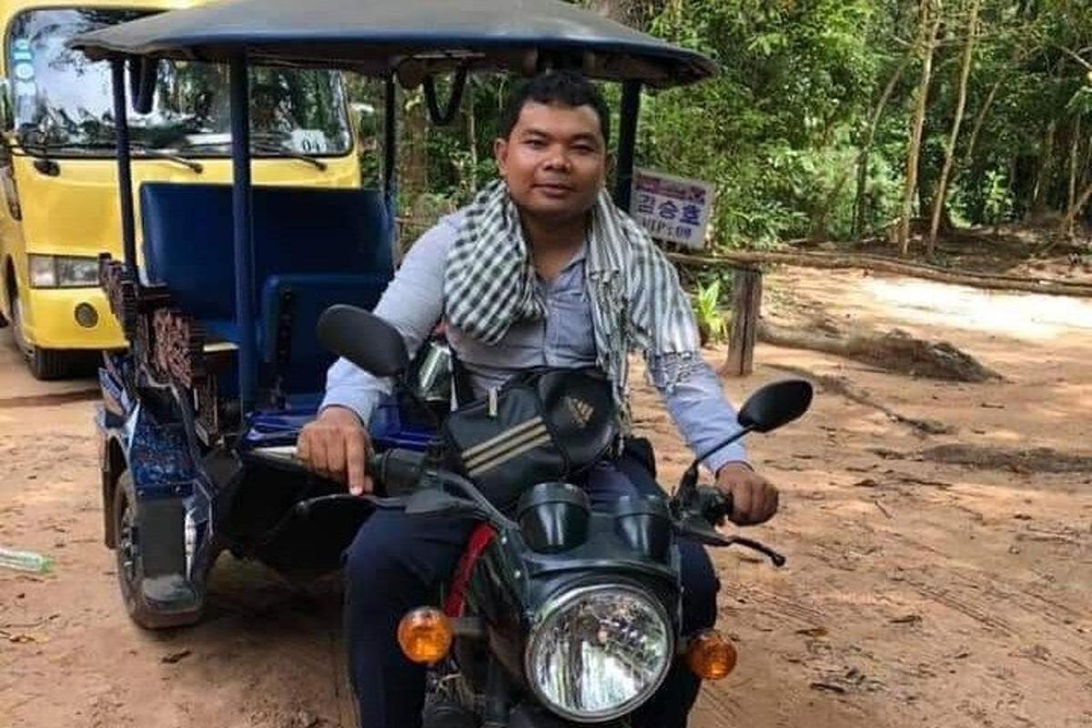 a man riding a motorcycle with a golf cart