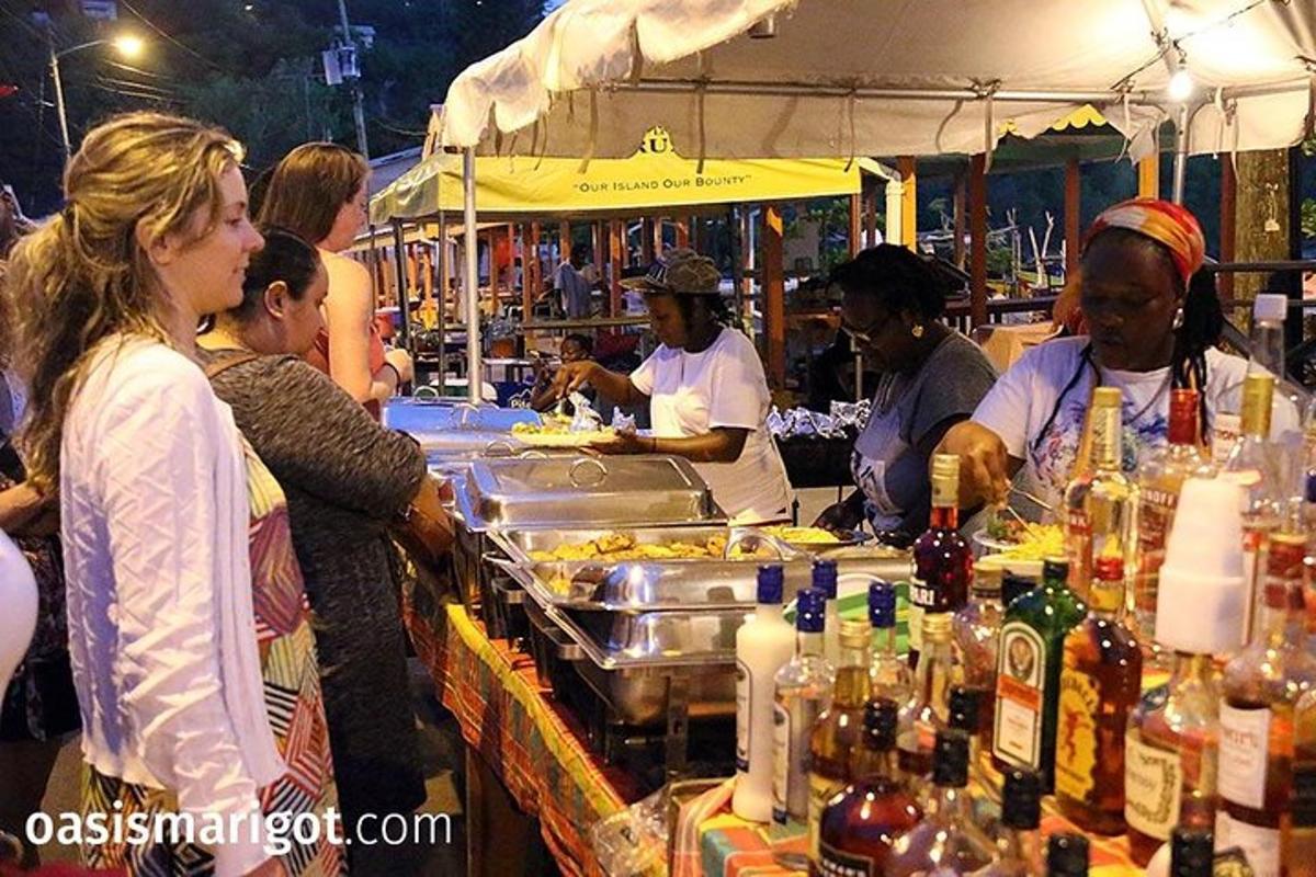 a group of people standing around a food bar at a market
