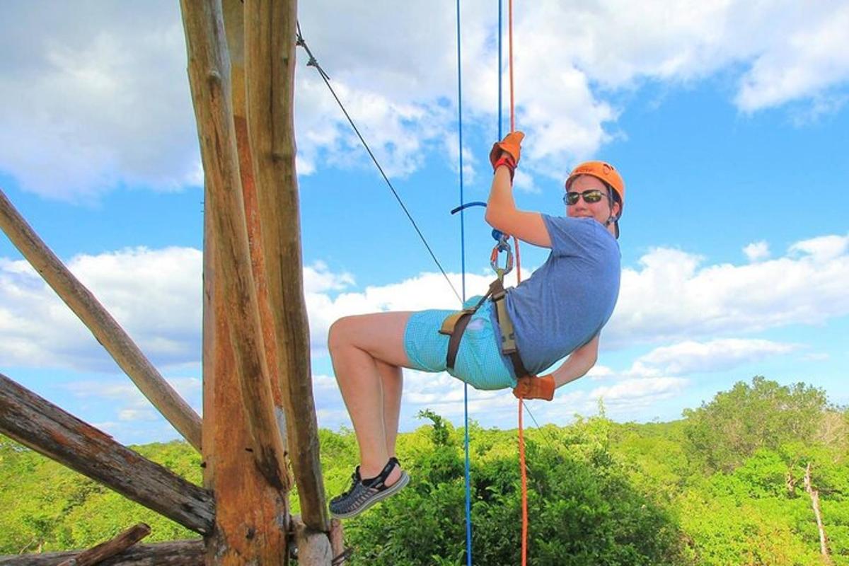 a woman on a zip line on a tree