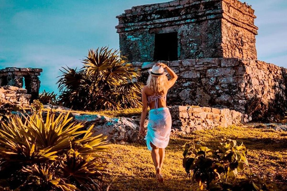 a woman in a dress walking in front of a building