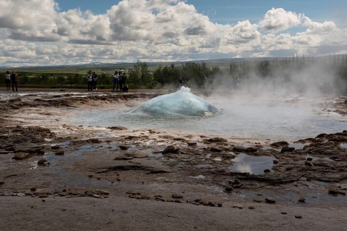 a group of people standing around a pool of water