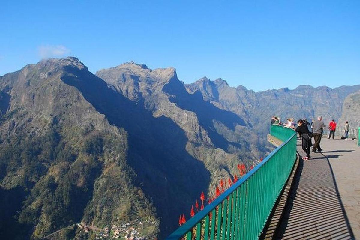 a group of people on a viewing platform on a mountain