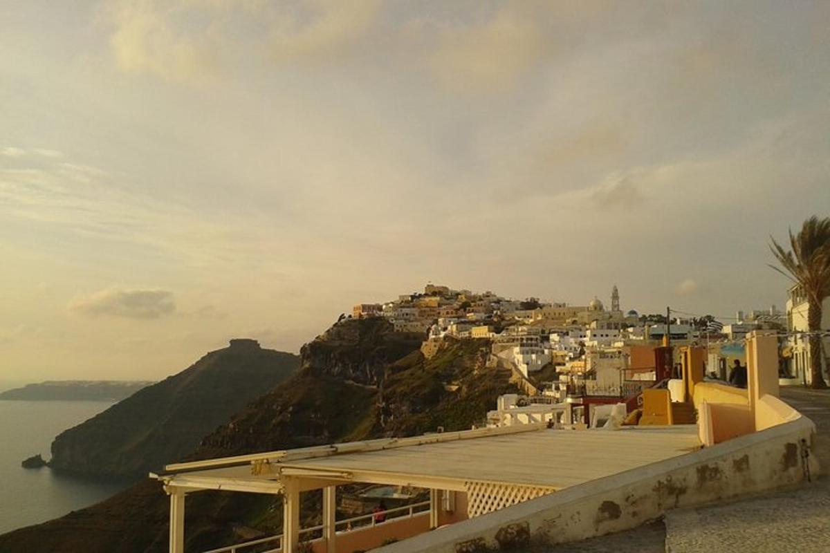 a view of a town on a hill next to the water