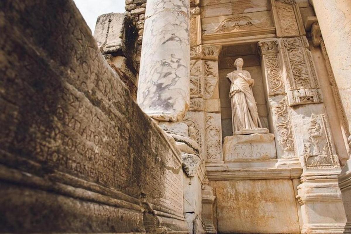 a statue of a woman on the side of a building