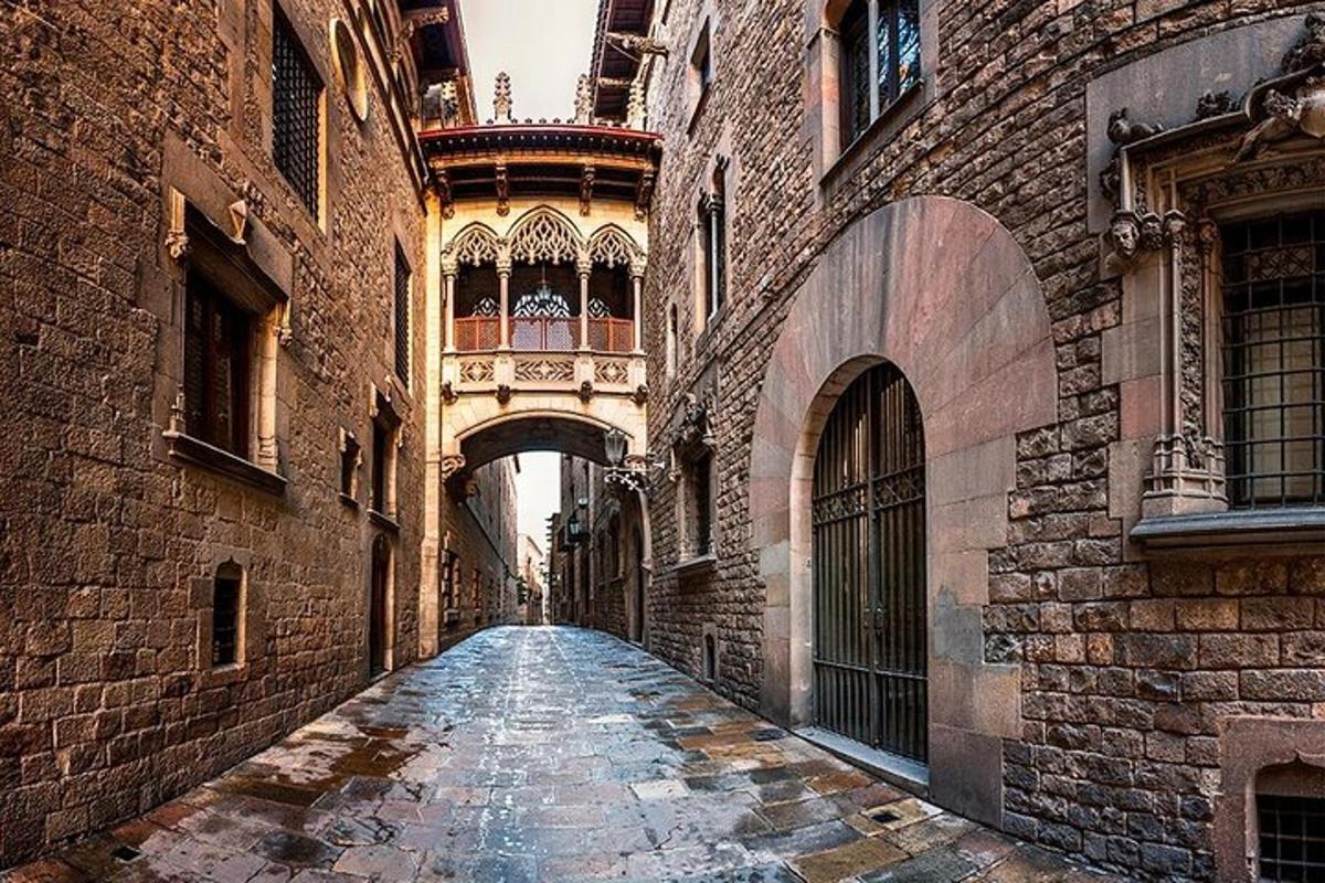 an alley way between two buildings with an archway