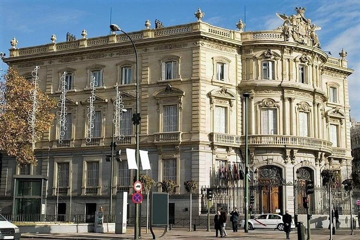 Un gran edificio con gente parada frente a él.