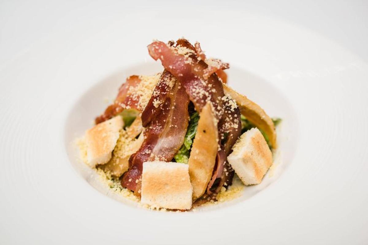 a plate of food with a sandwich on a white surface