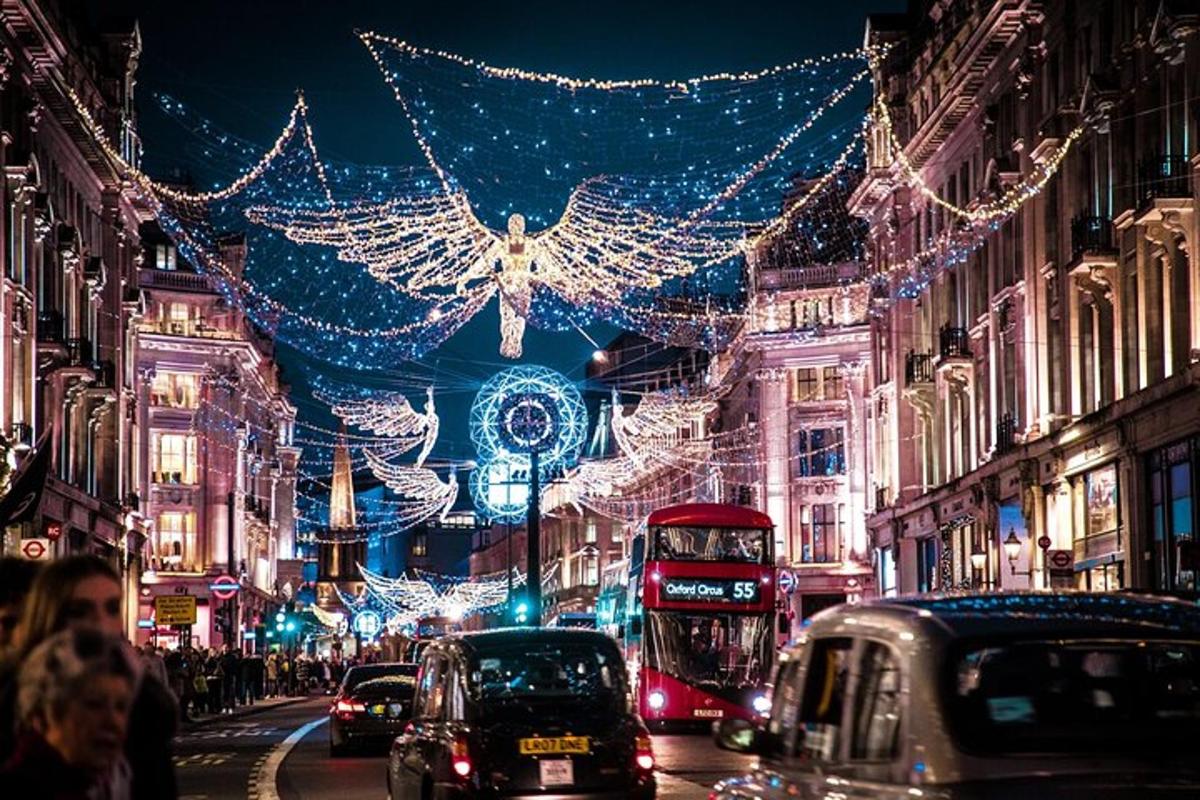 a busy city street filled with traffic with christmas lights