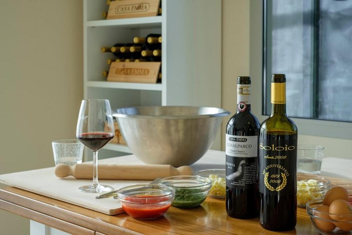 a counter with two bottles of wine and a glass