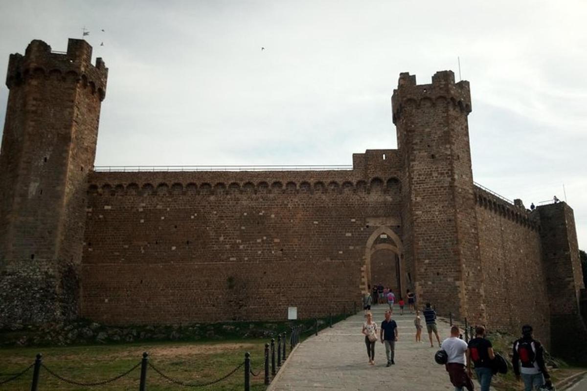people walking in front of a large brick building
