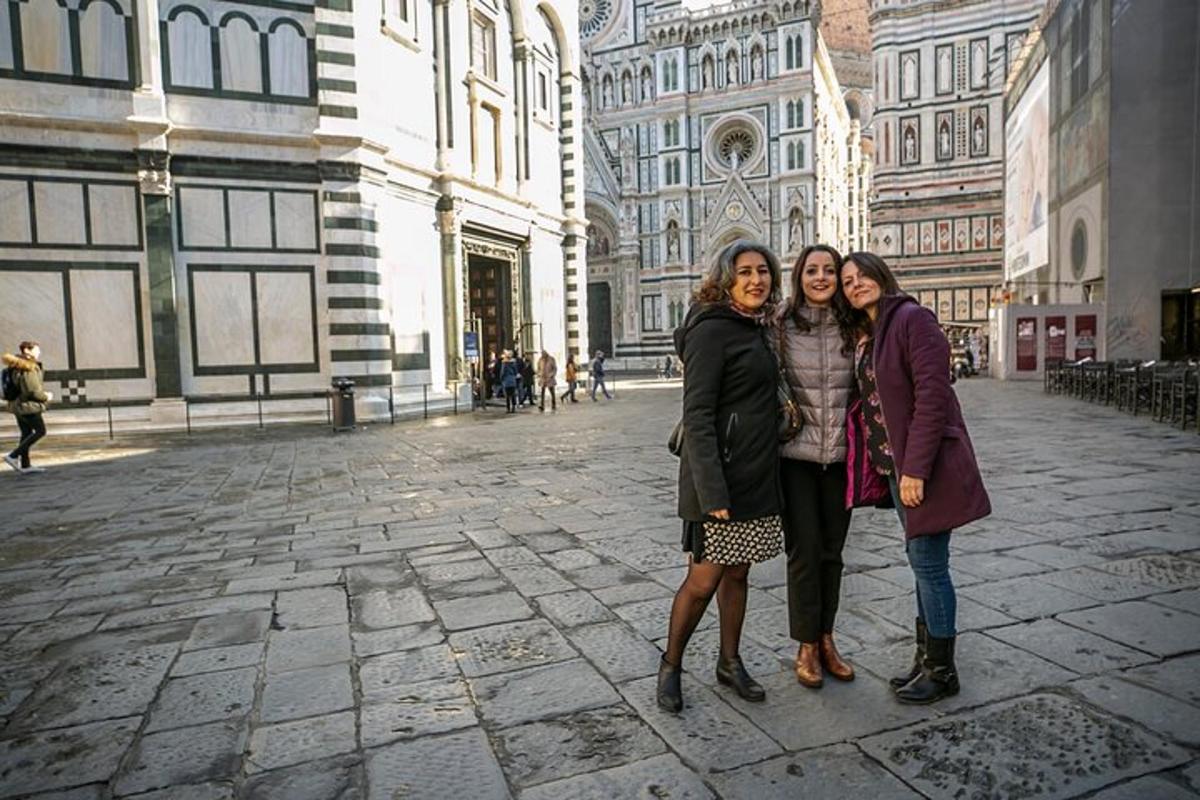 three women posing for a picture on a city street