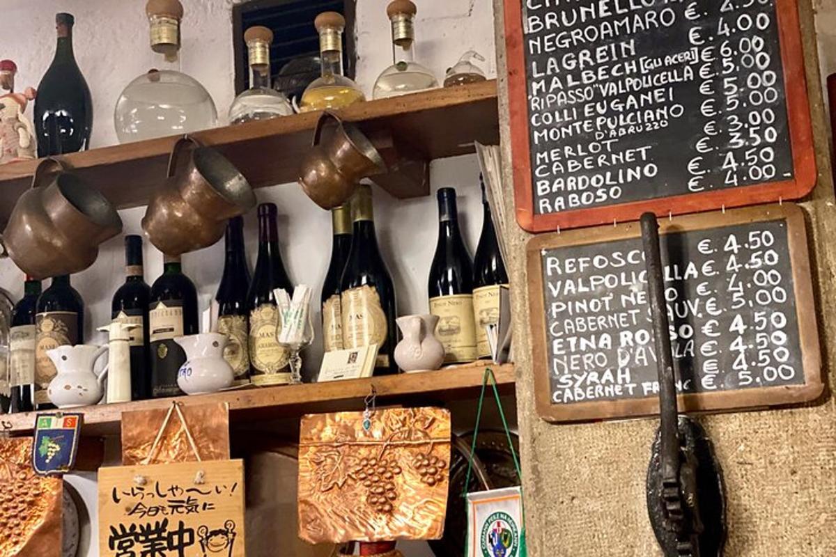 a bunch of wine bottles on a shelf with a sign