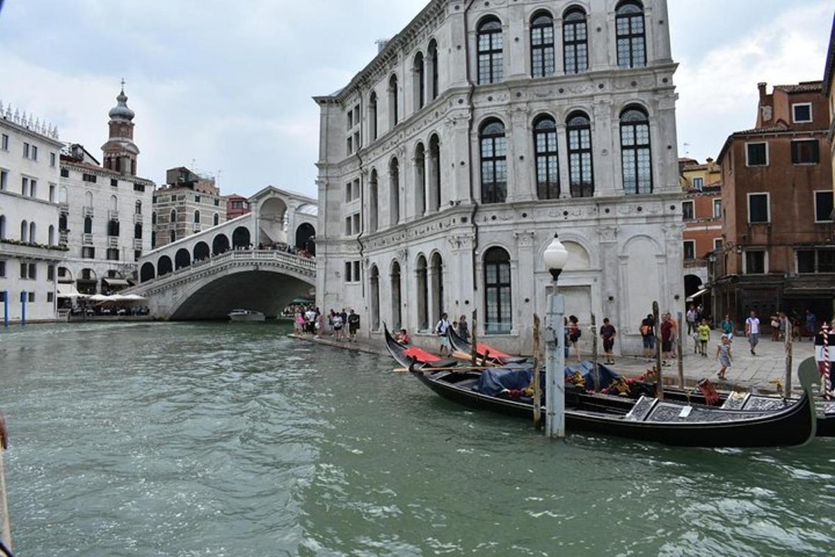 a group of gondolas on a river in a city