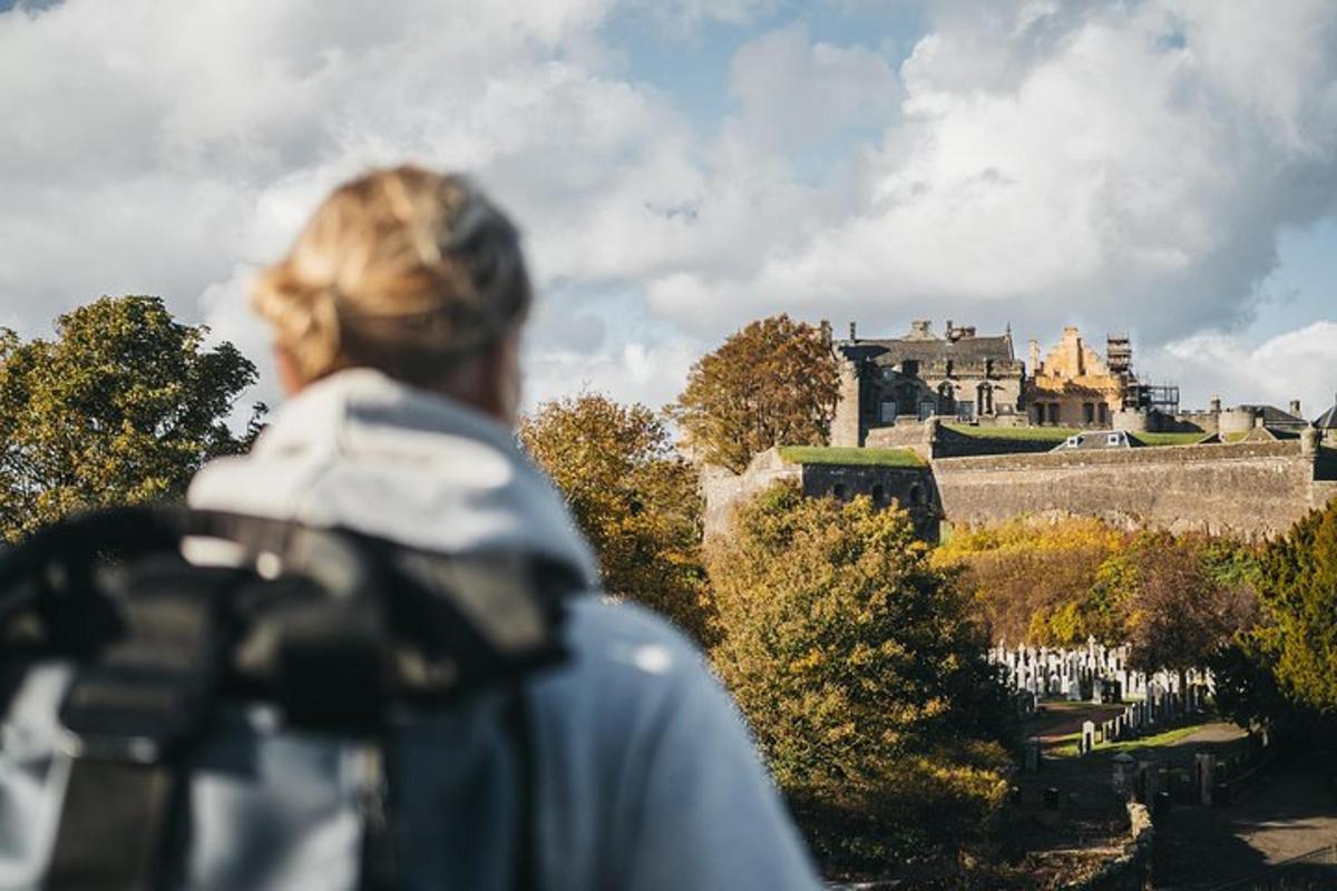 a woman with a camera looking at a castle