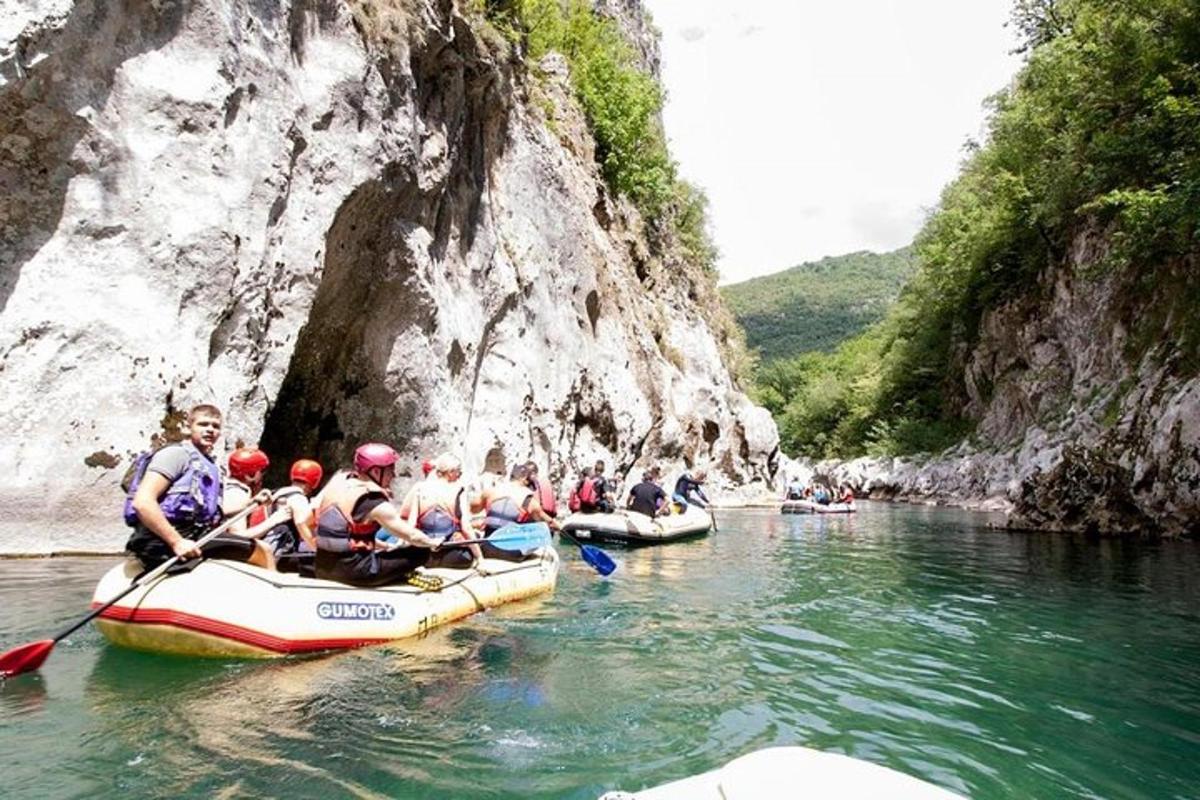 a group of people in rafts on a river