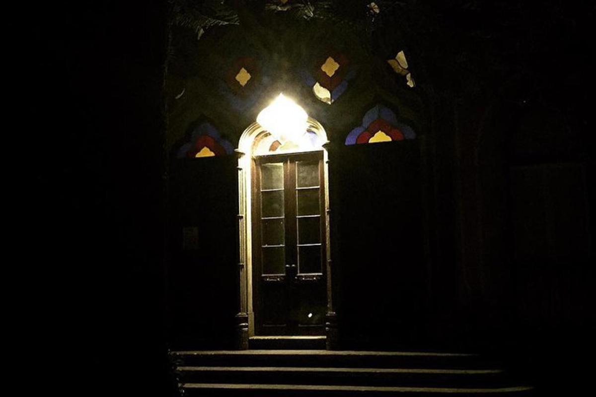 a door in a church with stairs in the dark