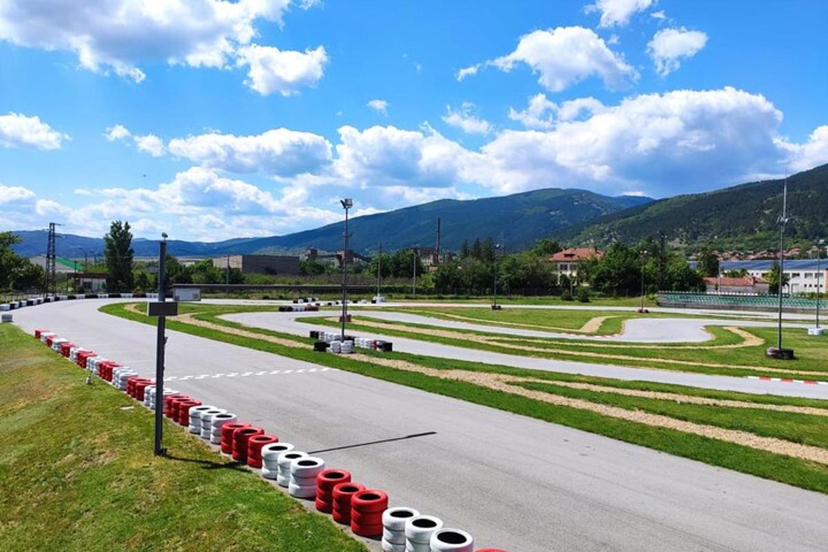 a road with red and white barrels in a park
