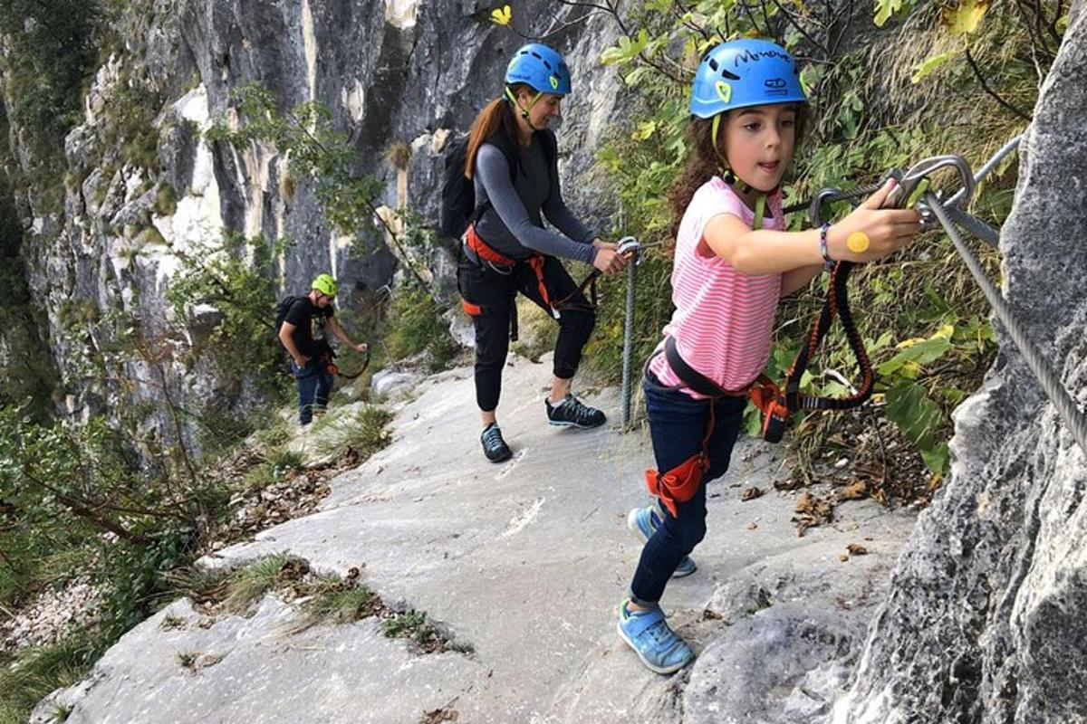 a little girl on a rock climbing on a mountain