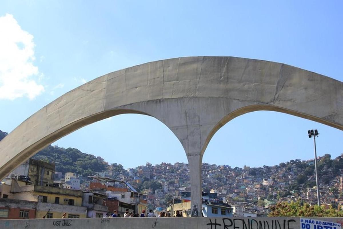 a large concrete bridge with a city in the background