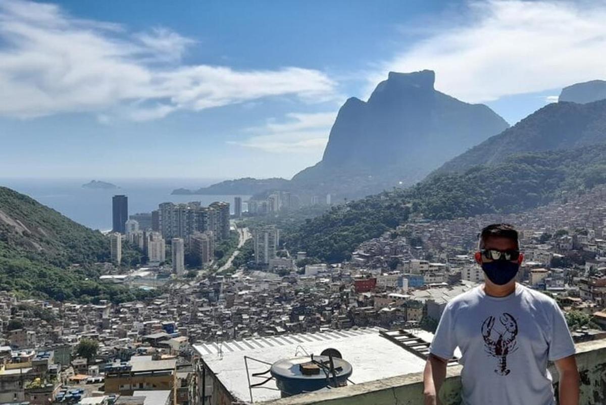 a man standing on top of a building with a face mask