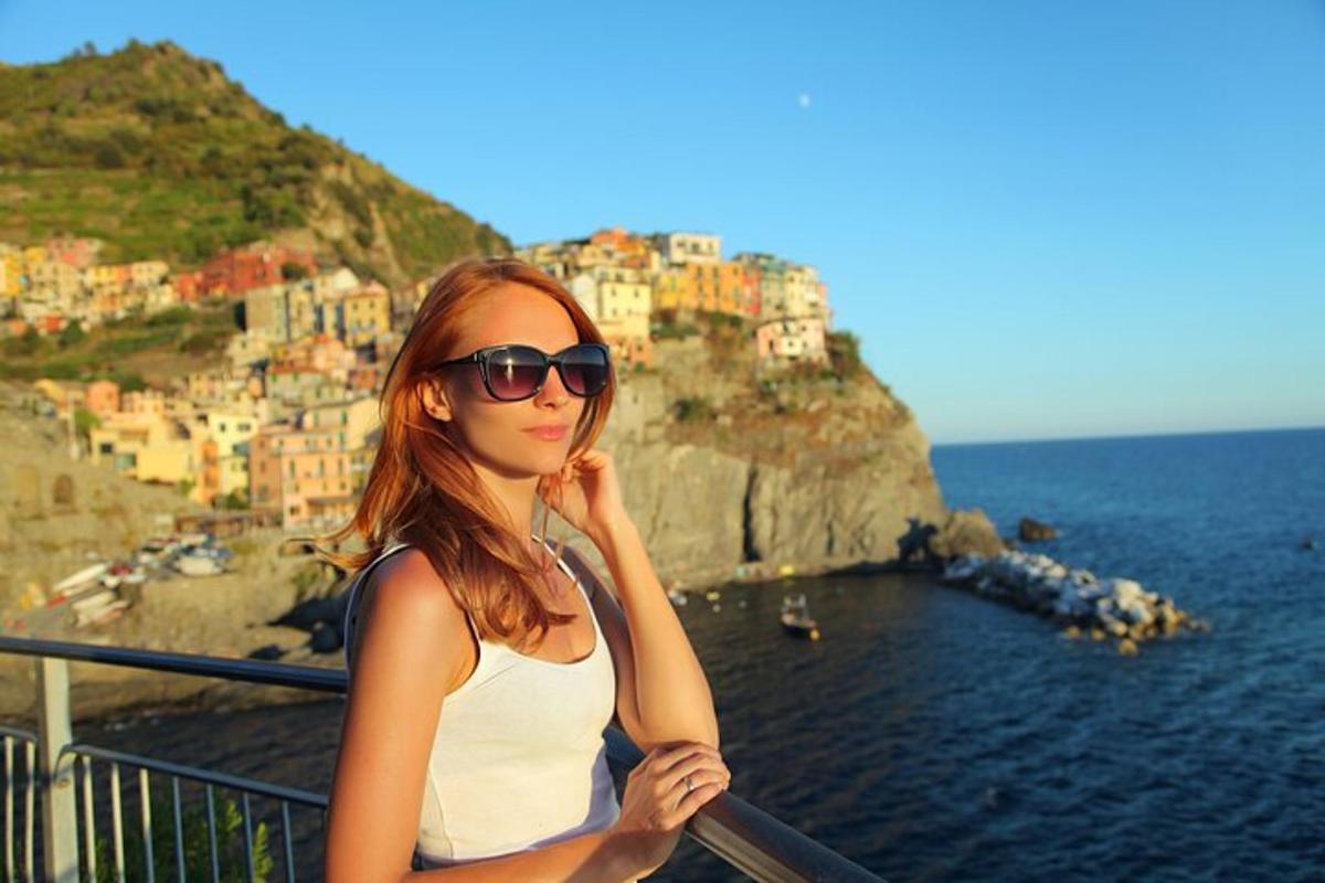 a woman standing on a balcony looking at the ocean