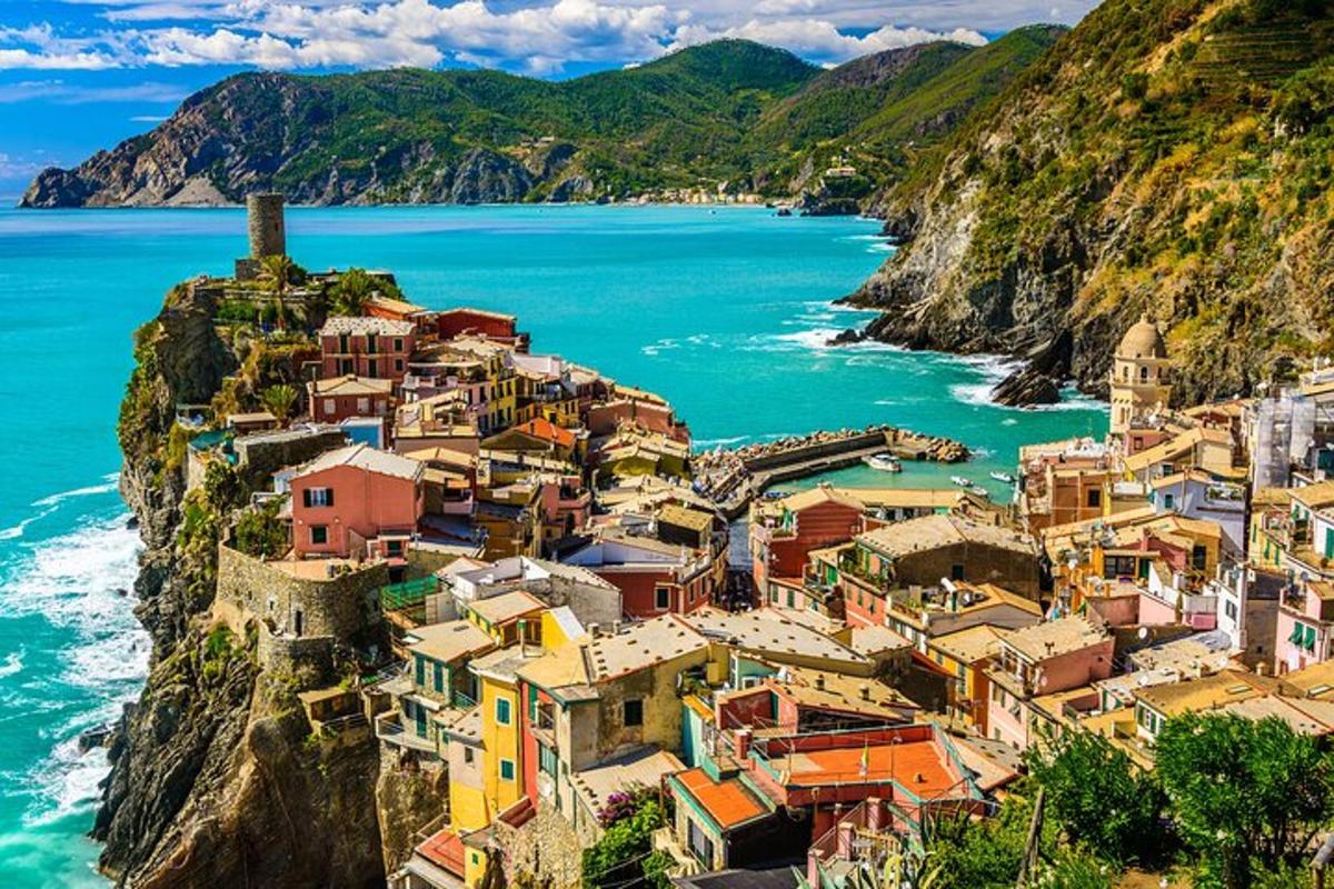 a group of houses on a cliff next to the ocean